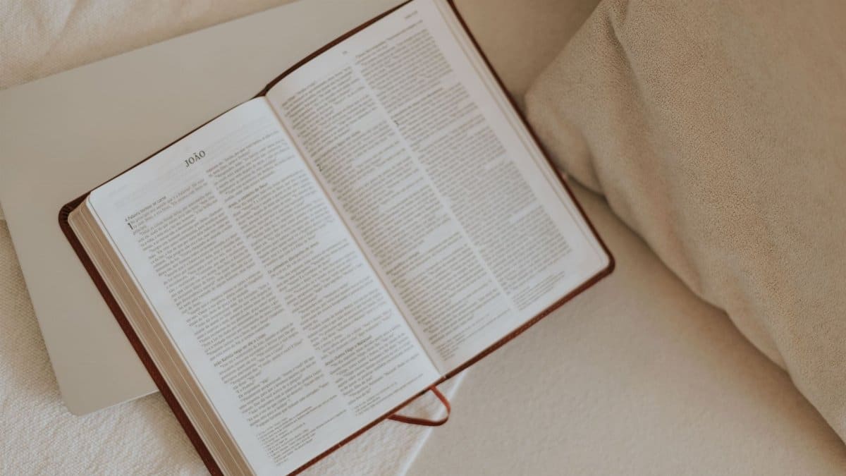 An open Bible on a beige blanket, inviting peaceful reflection and spiritual reading.
