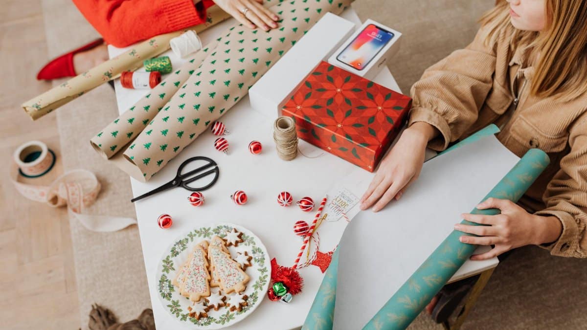 Festive setup showcasing Christmas gift wrapping and decorated cookies, perfect for holiday inspiration.
