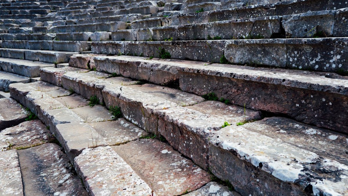 Close-up view of weathered stone steps in a historic Roman amphitheater, showcasing ancient architecture.