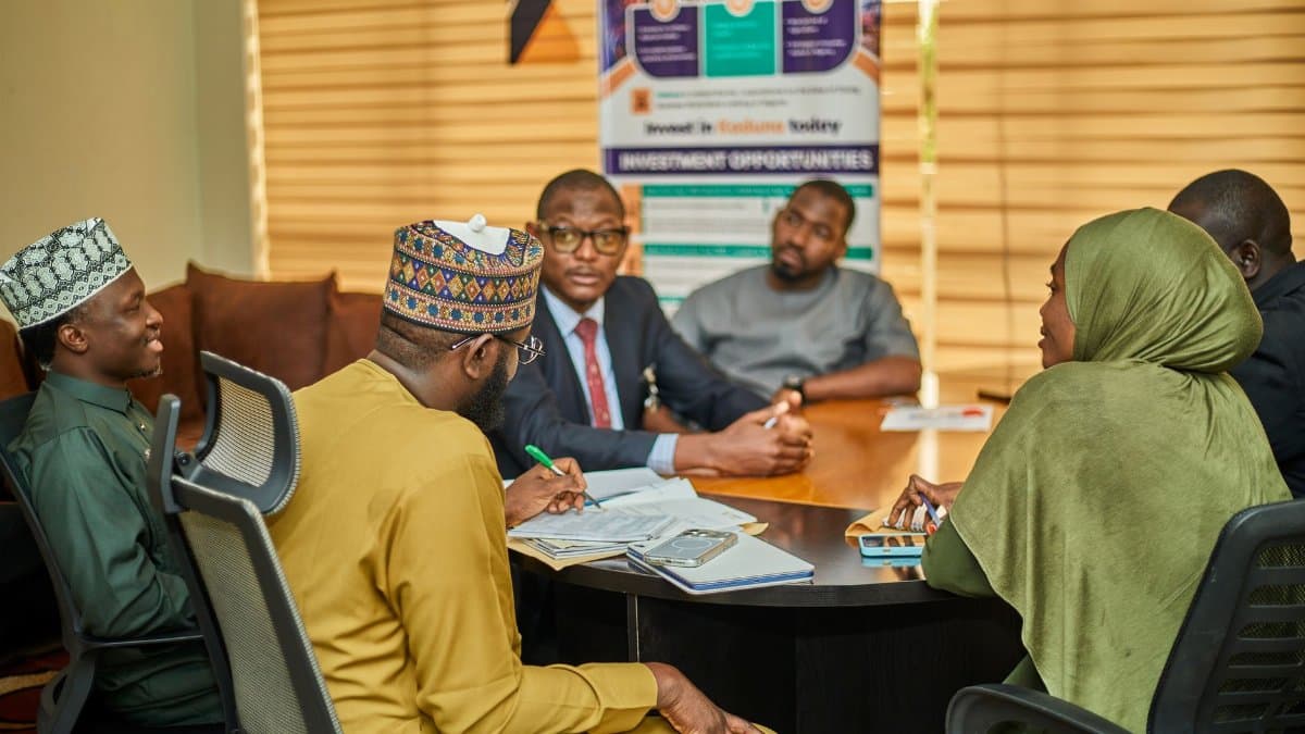 Professionals engaged in a business meeting in Kaduna, Nigeria discussing investment opportunities.