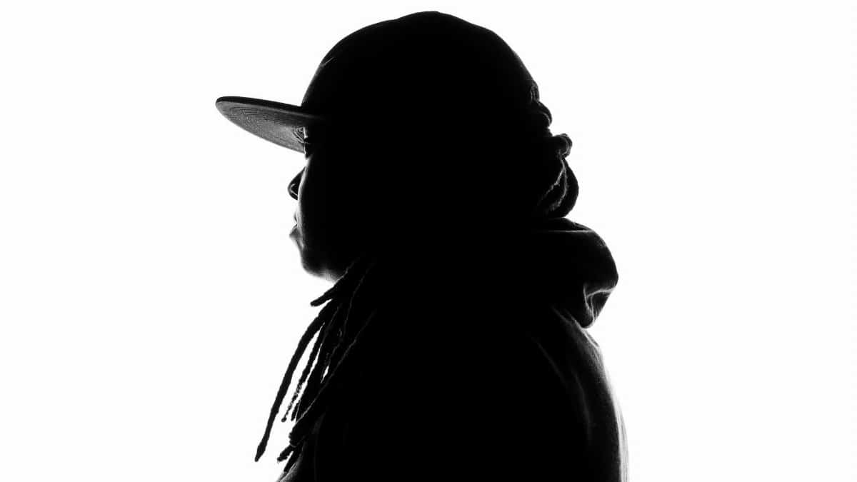 Black and white silhouette of a person wearing a hat, creating a mysterious and artistic profile.