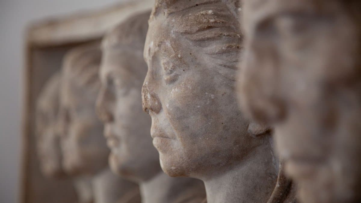 Detailed close-up of ancient marble head busts, showcasing fine craftsmanship.