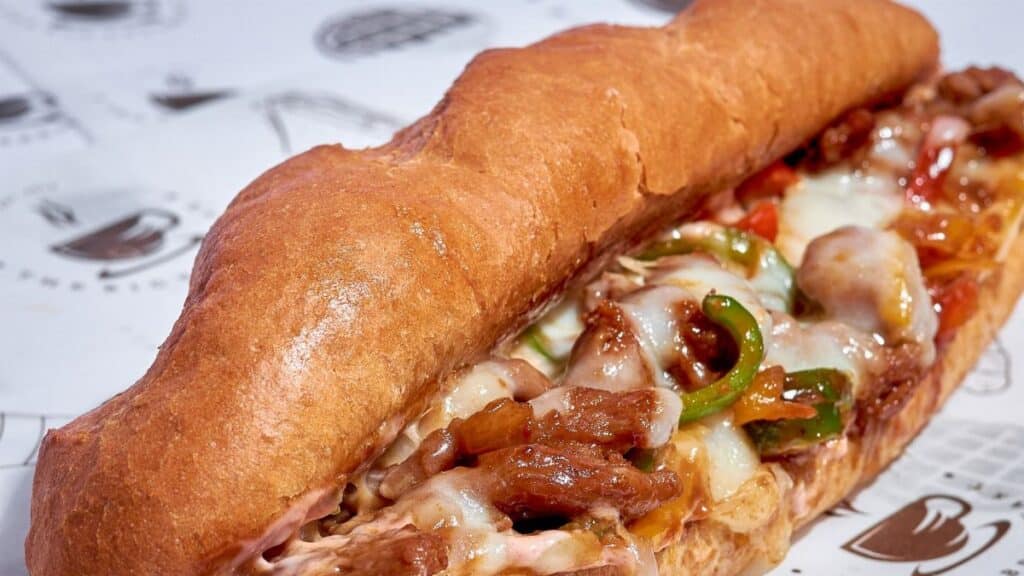 Mouthwatering Italian sub sandwich filled with melted cheese and fresh veggies, perfect for a quick meal.