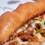 Mouthwatering Italian sub sandwich filled with melted cheese and fresh veggies, perfect for a quick meal.