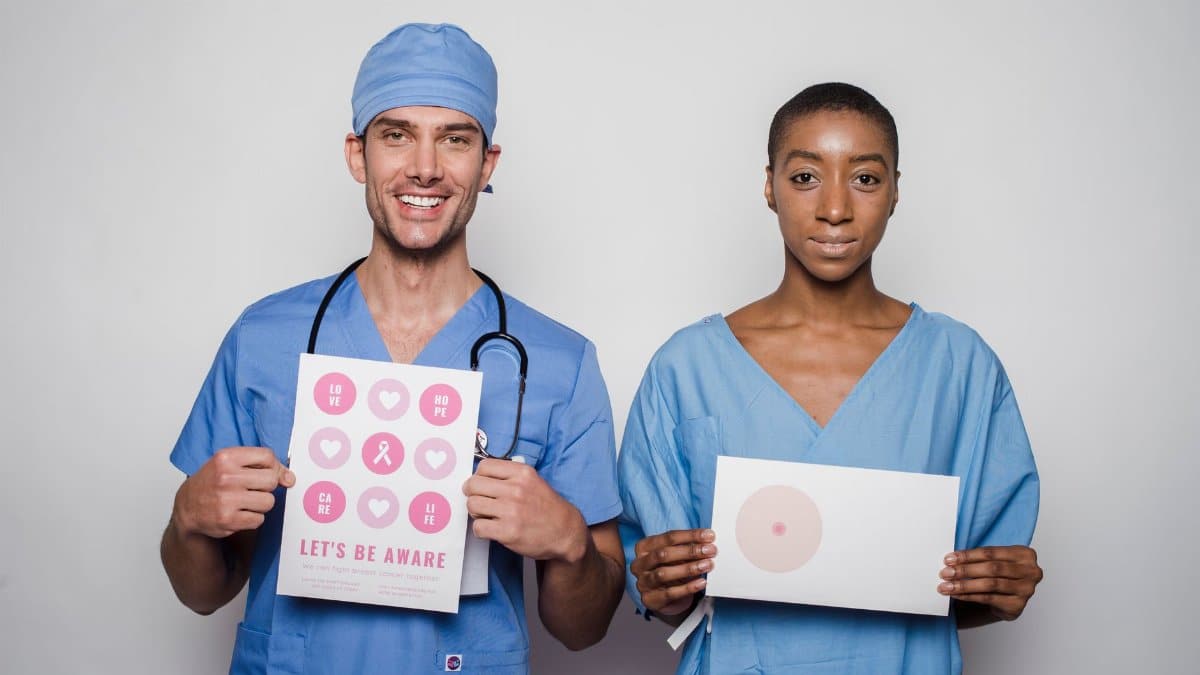 Healthcare professionals in scrubs promoting breast cancer awareness with informative posters.