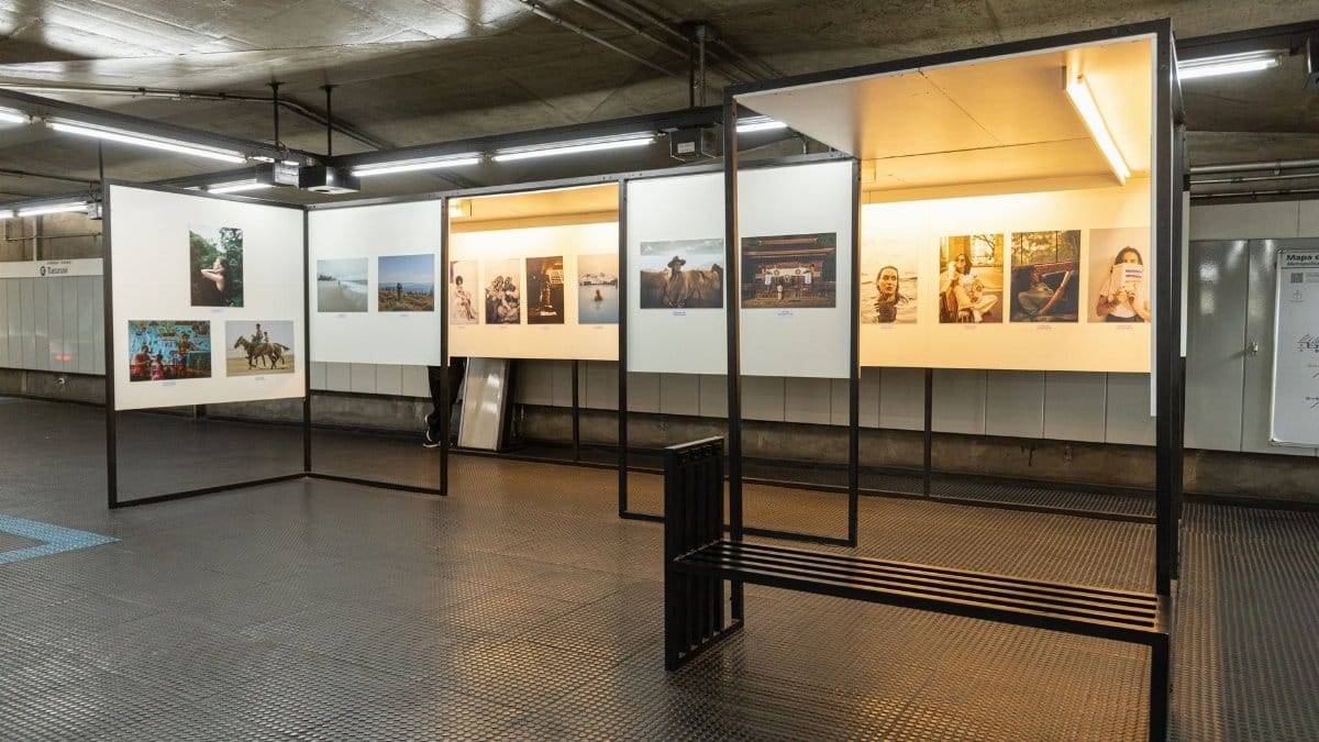 A photography display in a modern, illuminated underground station setting.