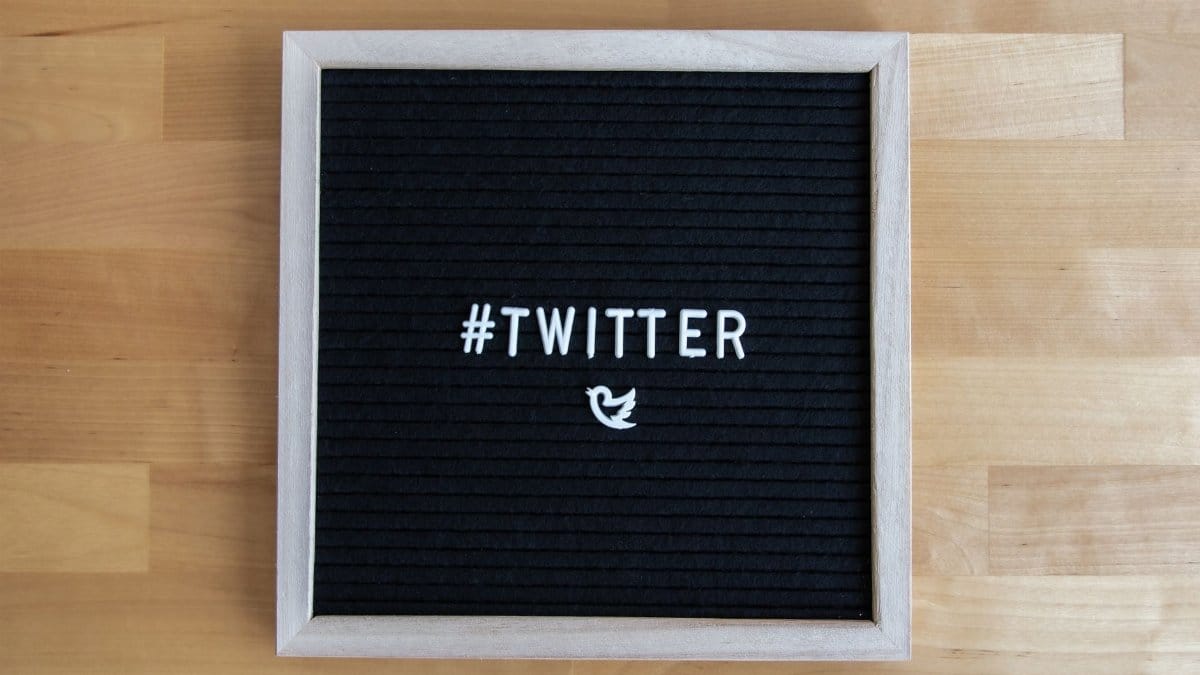 Black letter board with #Twitter hashtag and bird icon, ideal for social media themes.