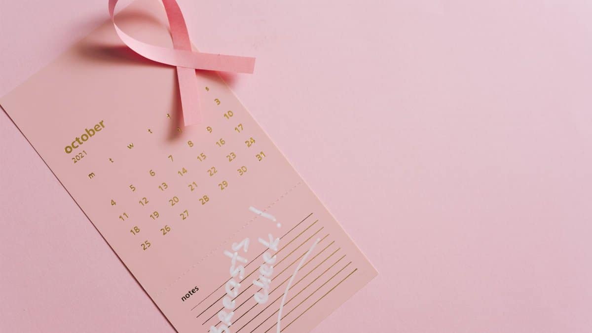 Pink October calendar with ribbon symbolizing breast cancer awareness, emphasizing early detection.