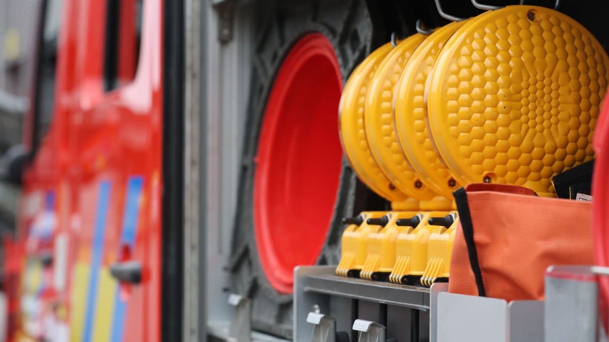 Colorful fire truck storage with safety equipment featuring vivid reds and yellows.