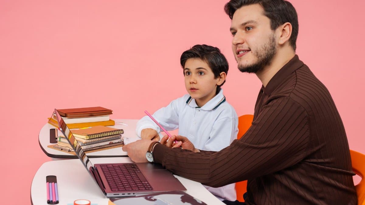 Male teacher and young boy studying together at a desk in Yalova, Türkiye.