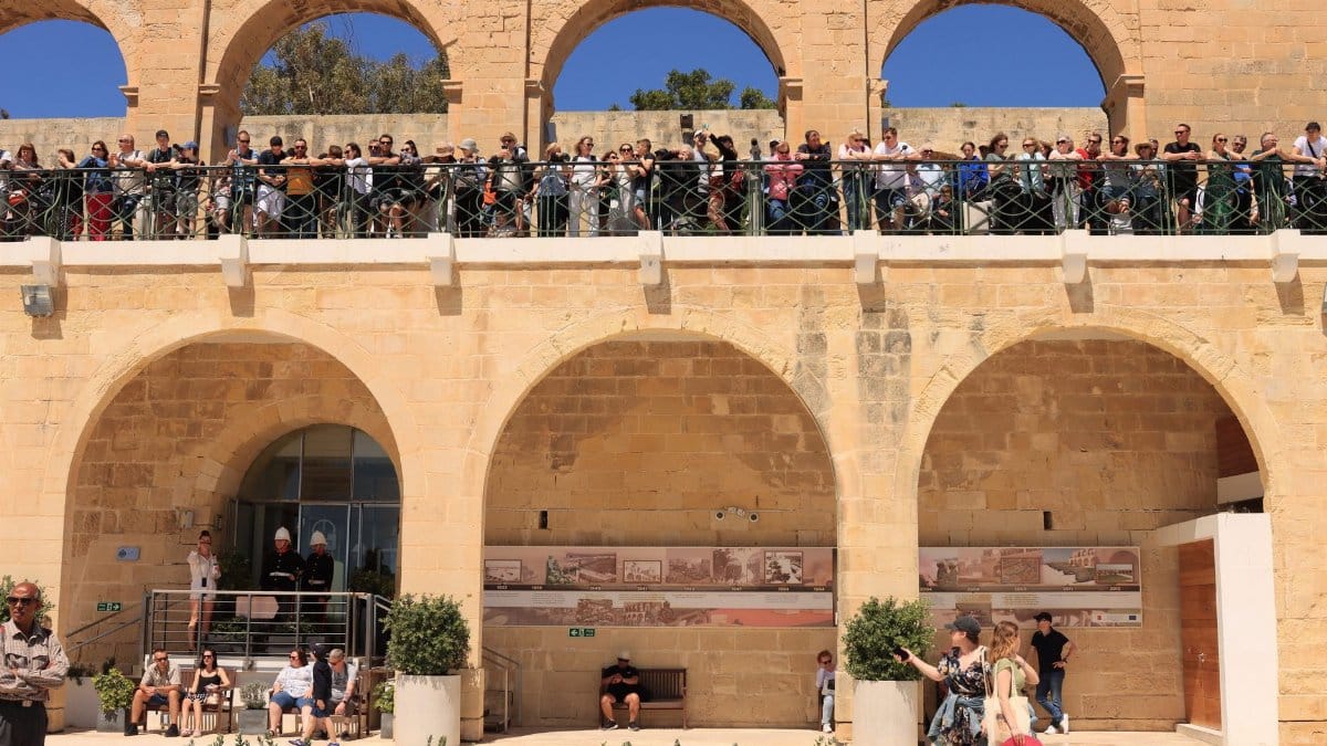 Crowds admire views from Upper Barrakka Gardens in Valletta, Malta.