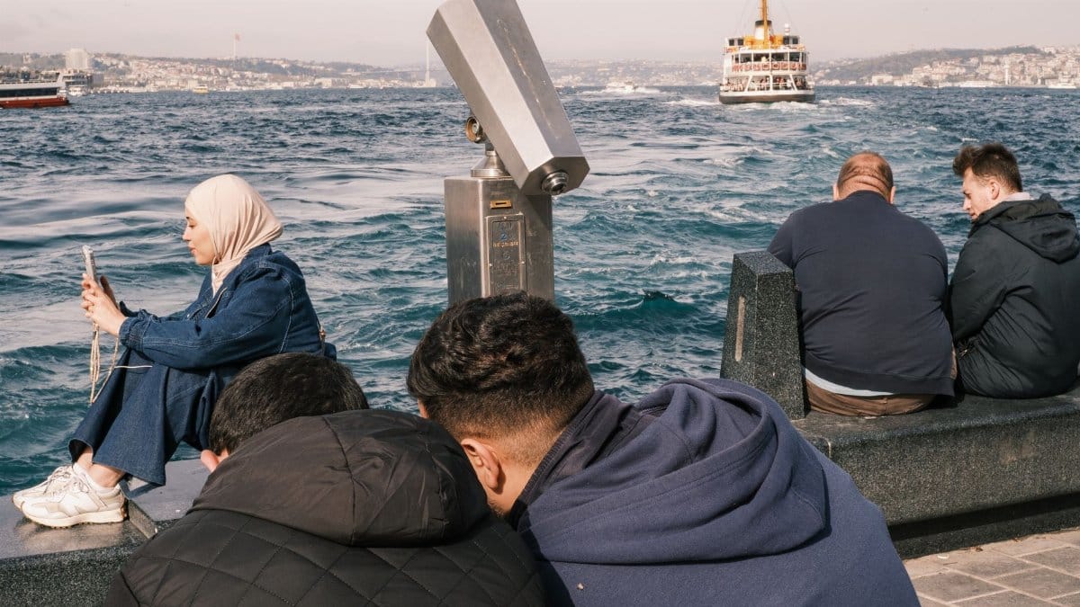 People enjoying a sunny day by the Bosphorus Strait, Istanbul, Turkey.