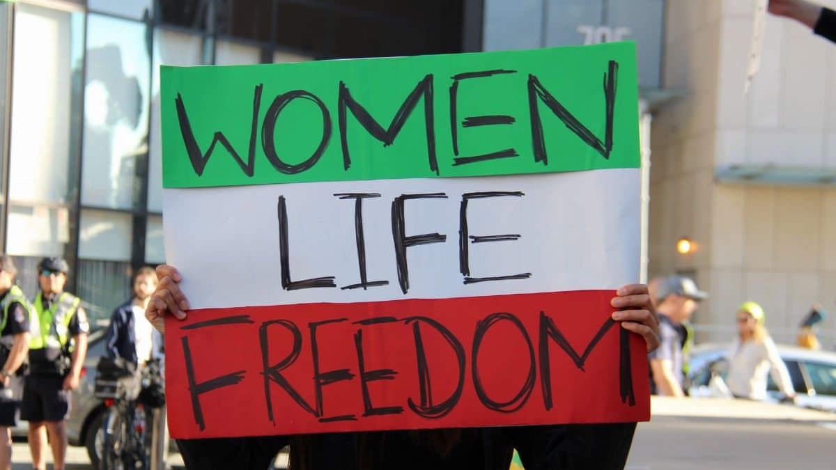 A powerful protest in Vancouver highlighting women's rights with bold message 'Women Life Freedom'.