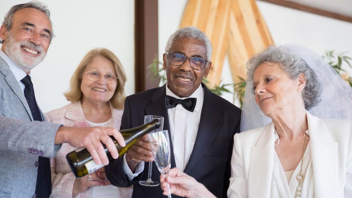 A joyous wedding celebration featuring a couple with friends, dressed elegantly and toasting with champagne.