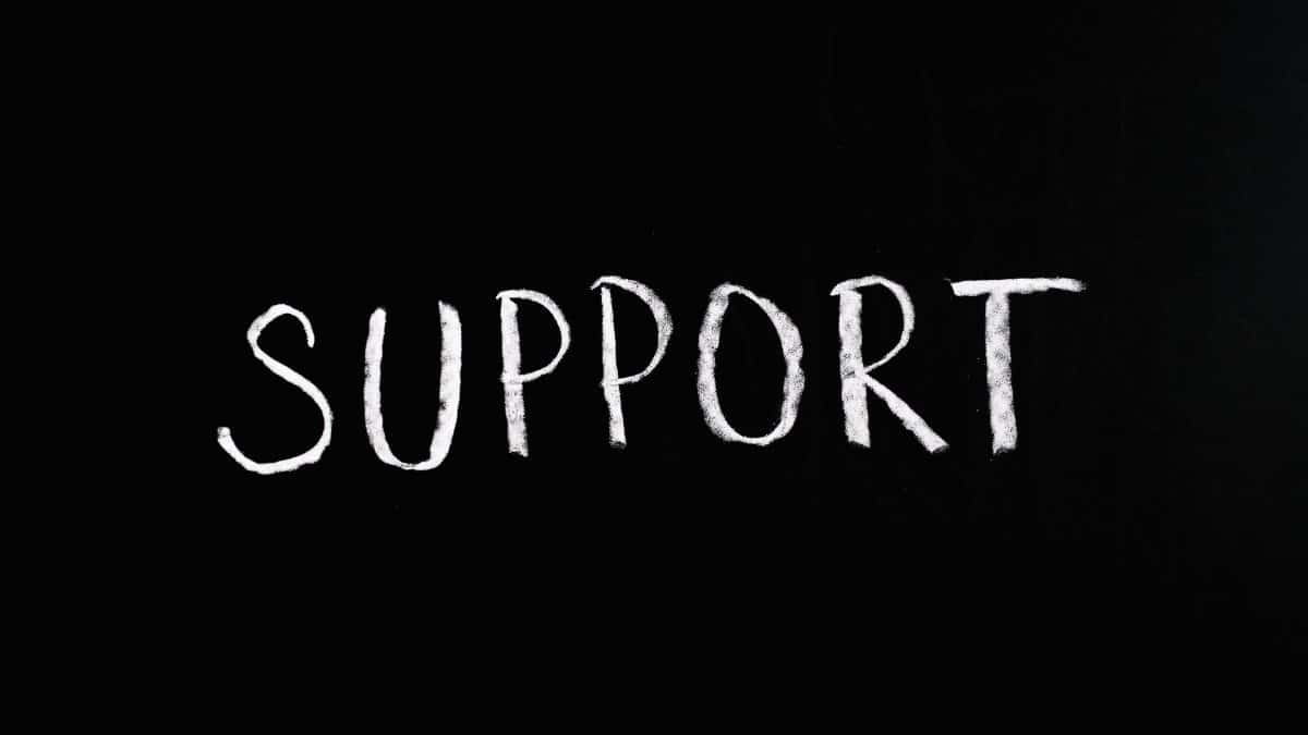 Chalkboard with the word 'Support' written in white chalk on a black background.