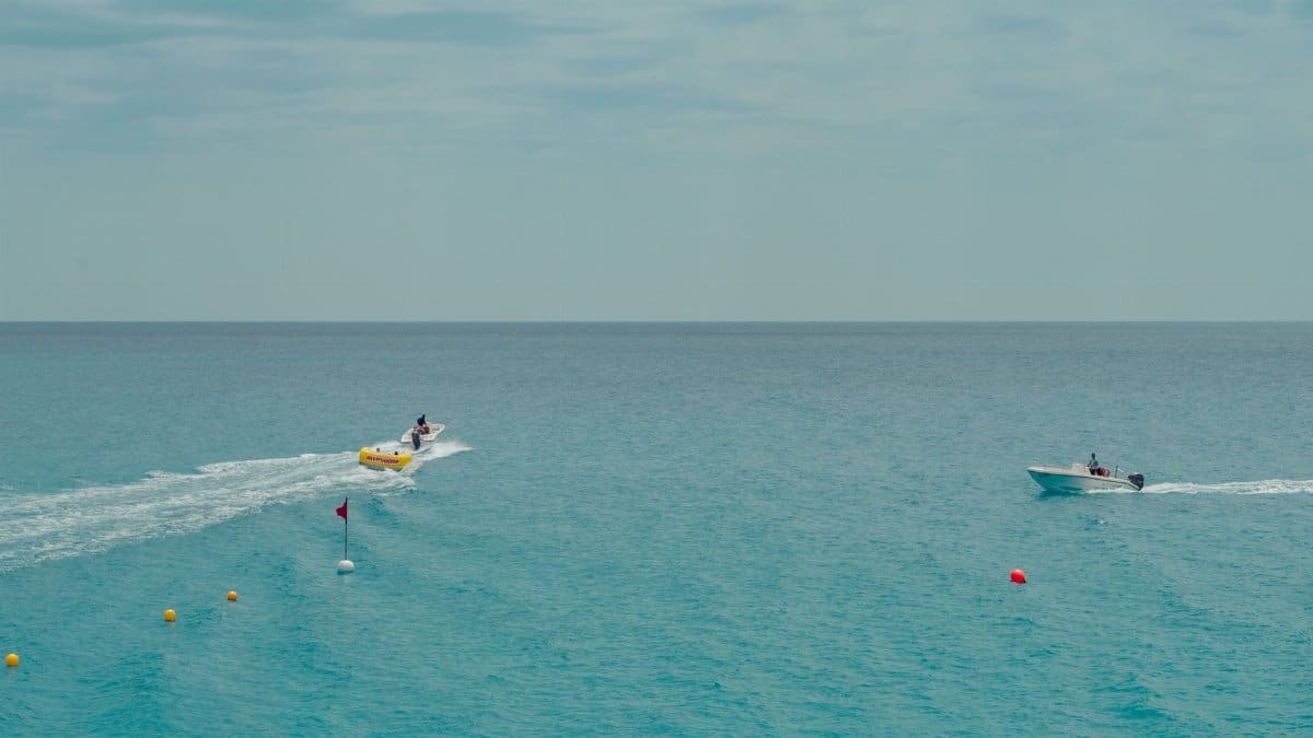 Boating on a serene blue sea with buoys in view, capturing leisure and recreation.