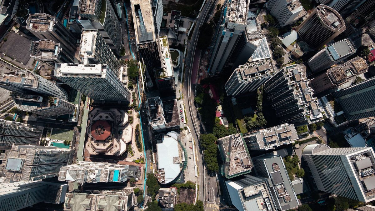 Stunning aerial shot of city skyscrapers and roads showing urban landscape and architecture.