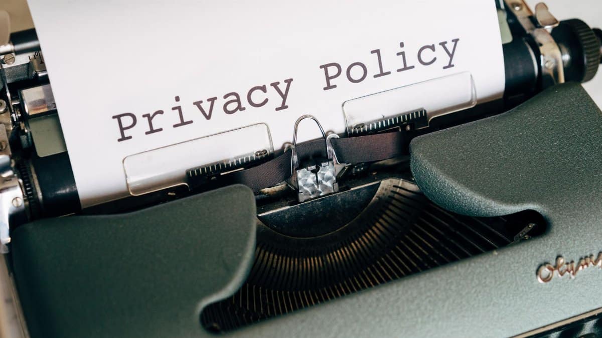 Close-up of a vintage typewriter featuring a privacy policy document in focus, highlighting classic technology.