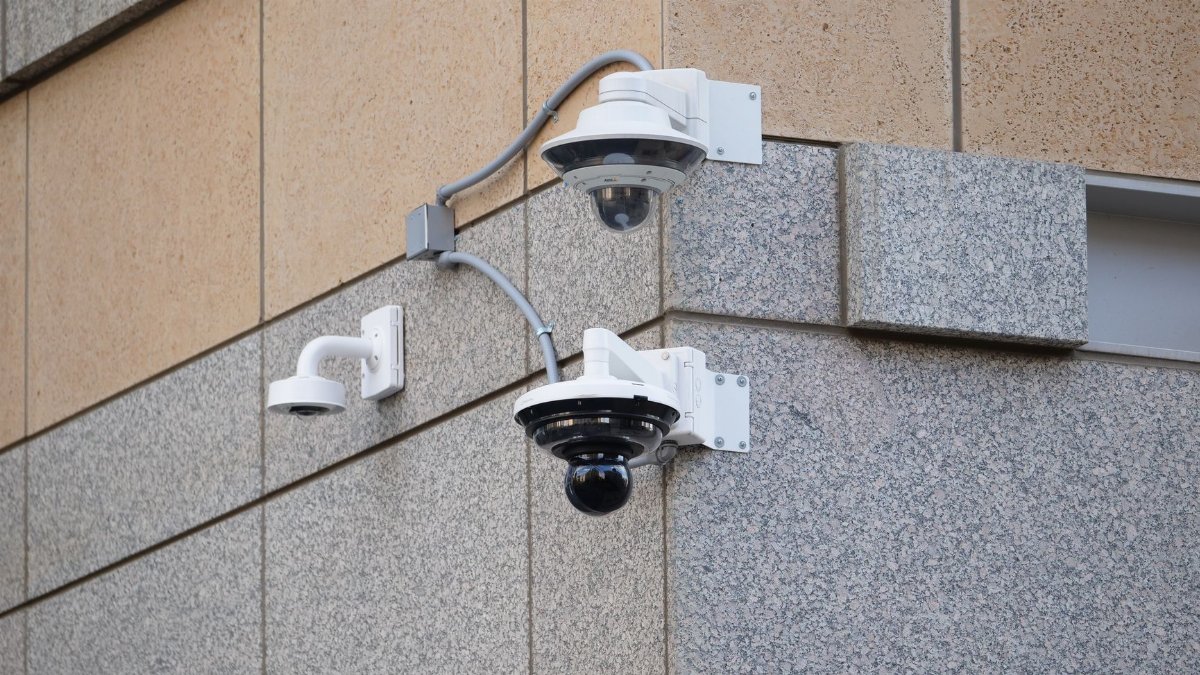 Security cameras mounted on a building wall providing surveillance and safety.