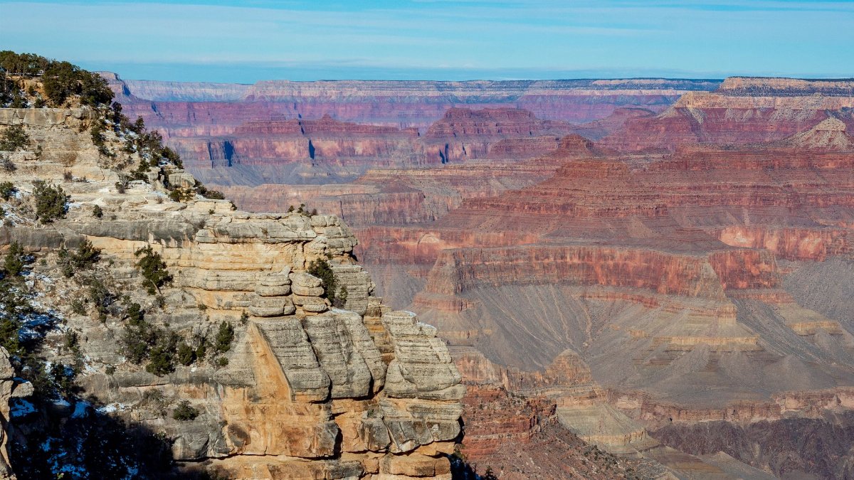 Breathtaking view of the Grand Canyon West showcasing its colorful rock formations and vast landscape.
