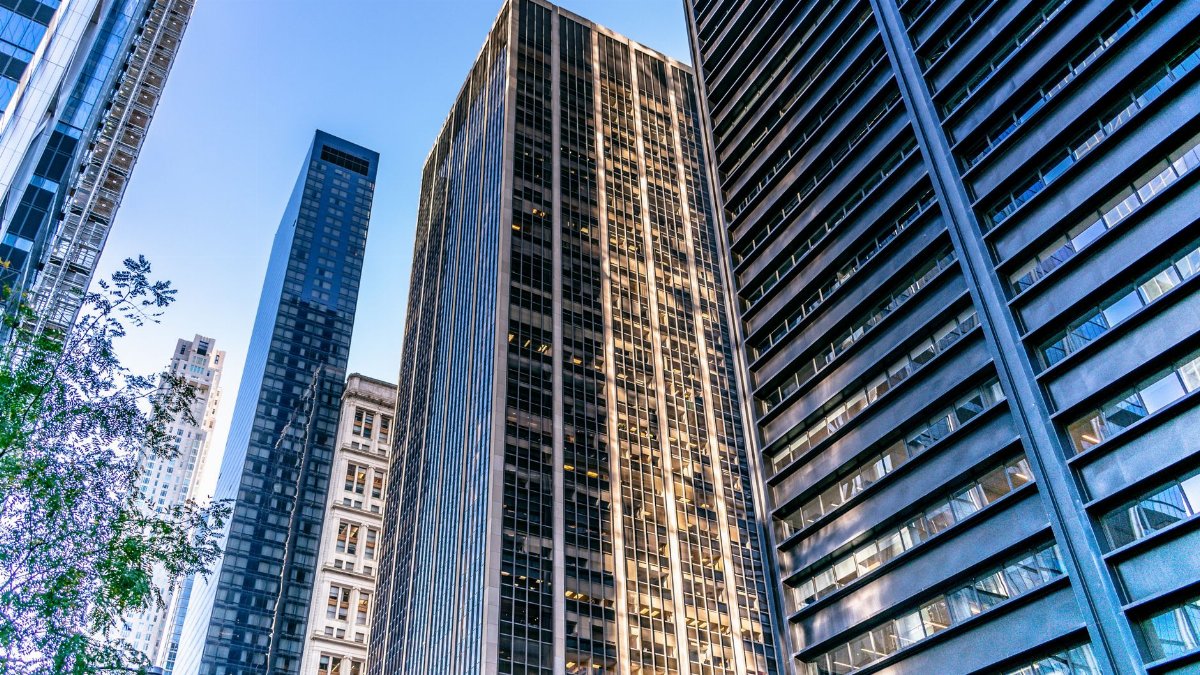 High-rise buildings in New York City's urban skyline under clear blue sky.