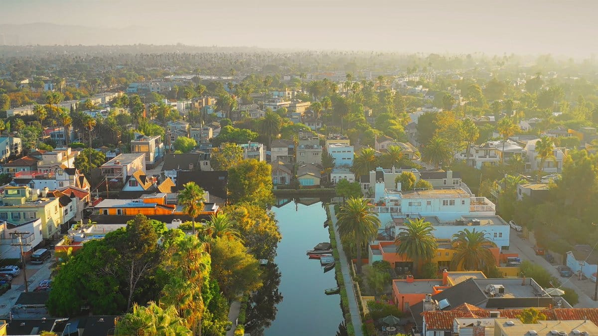 A scenic aerial view of a vibrant neighborhood with a canal running through it in Dĩ An, Vietnam.