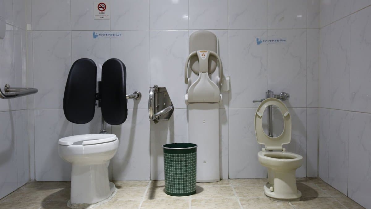Image of a public restroom with accessible toilet facilities and a baby changing station.