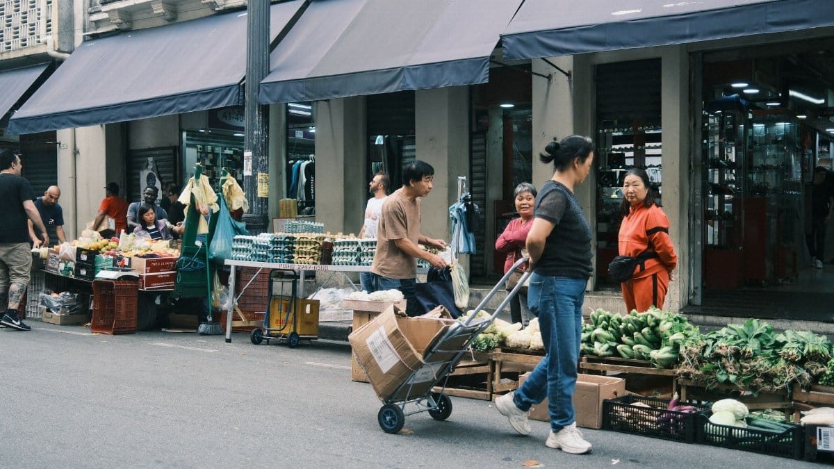 Bustling street market scene in São Paulo with fresh produce and local shoppers.