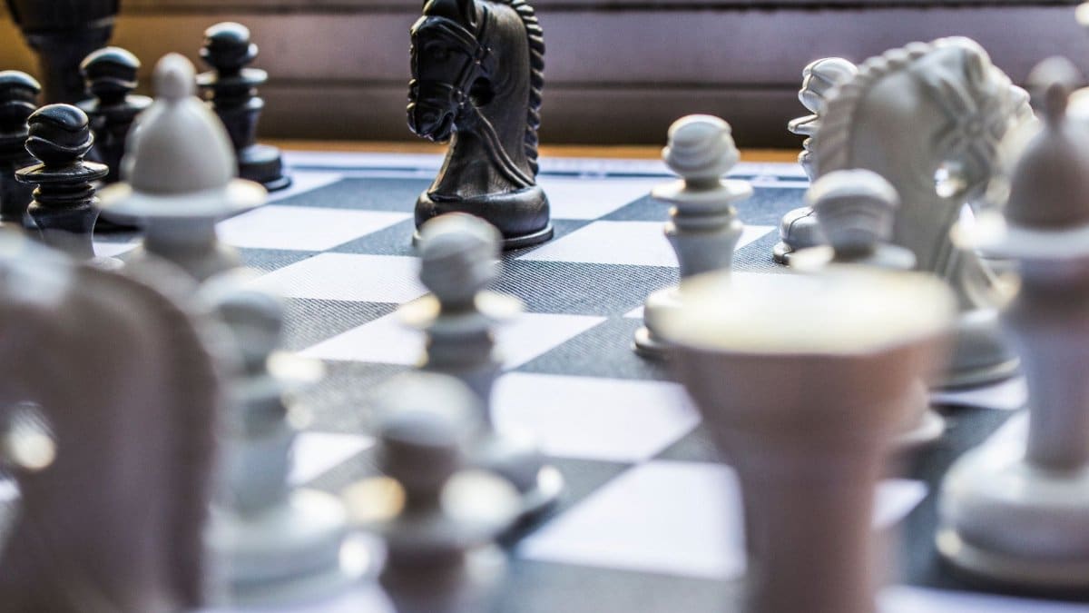 Close-up of a chessboard with pieces in focus, highlighting strategic gameplay.