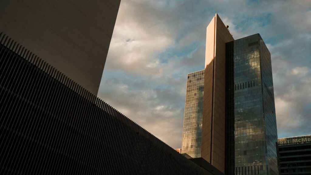 Tall skyscrapers in downtown Phoenix reflecting the sunset sky, showcasing modern architecture.