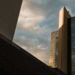 Tall skyscrapers in downtown Phoenix reflecting the sunset sky, showcasing modern architecture.