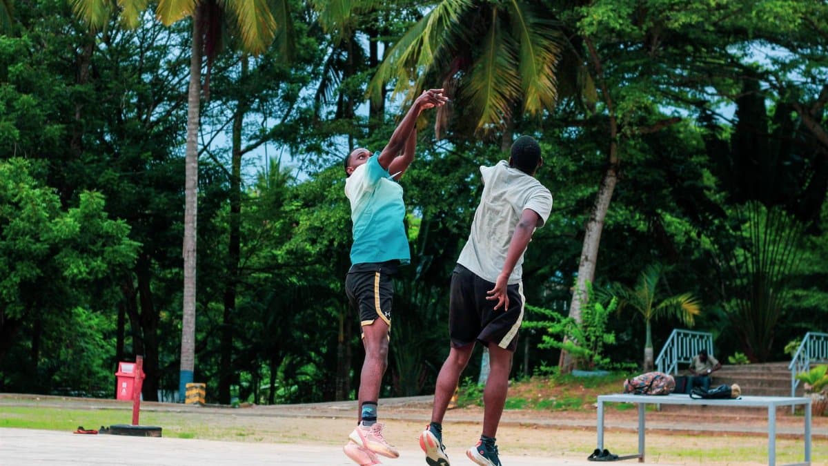 Energetic game of basketball outdoors, showcasing athleticism and competitive spirit.