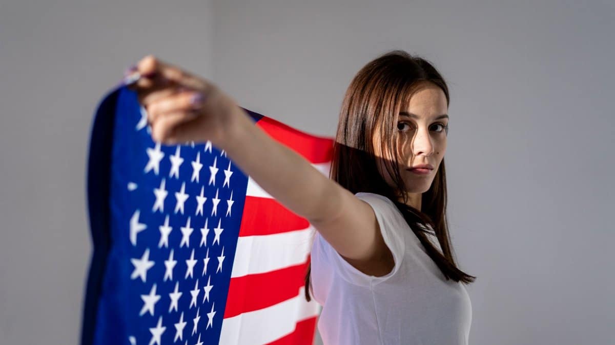 A woman holding the American flag, symbolizing patriotism and independence.