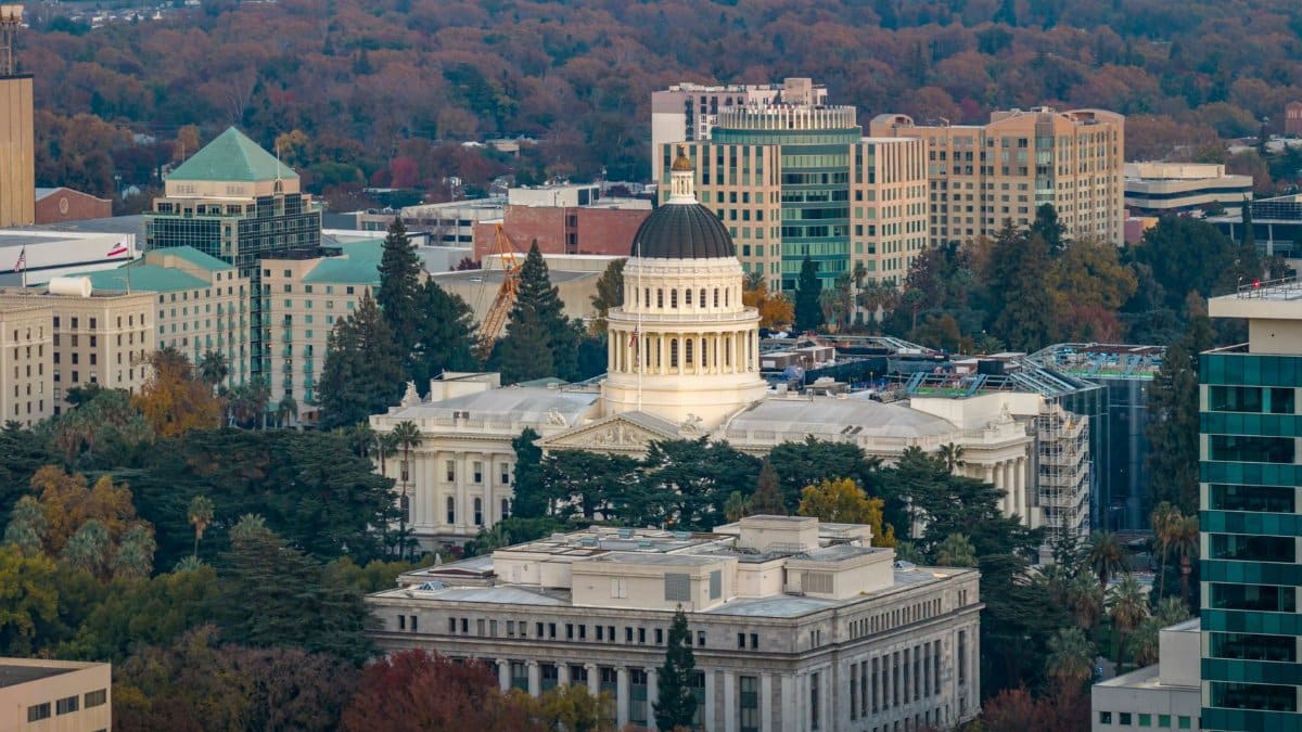 Stunning aerial view of the iconic California State Capitol in Sacramento surrounded by cityscape.