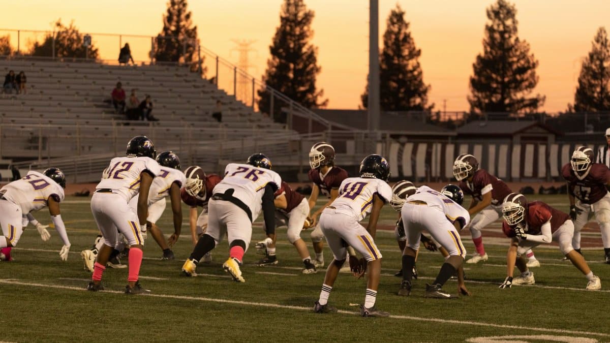 Intense American football game between two teams at sunset in Roseville, California.
