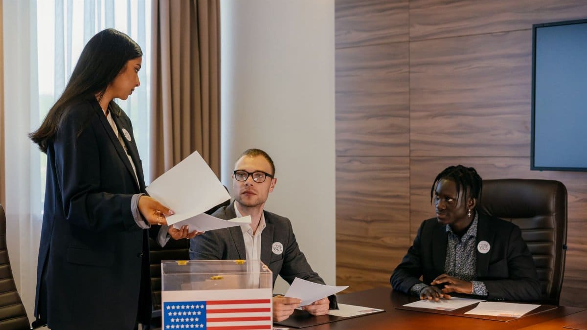 A diverse group of professionals deliberating in a conference room about election plans.