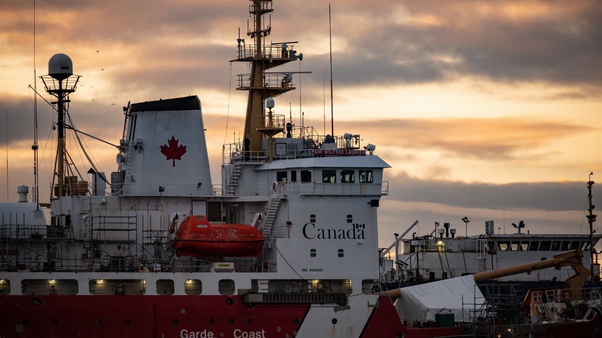 Close-up of a Canadian Coast Guard ship docked at sunset, showcasing maritime details.