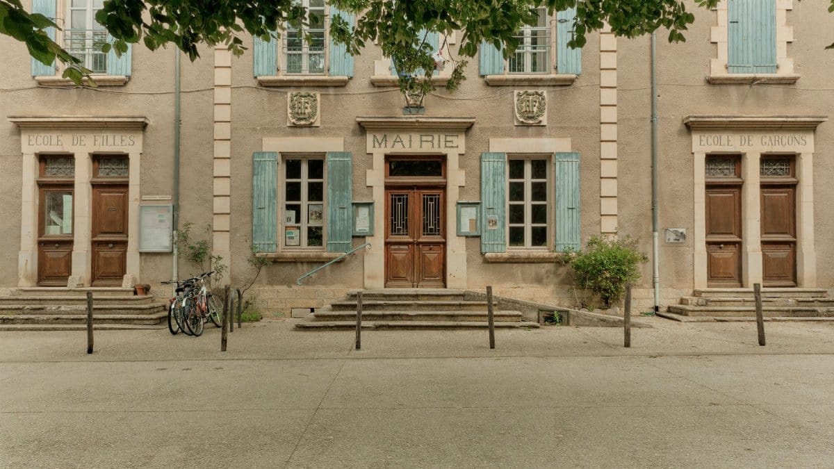 Front view of a traditional French town hall in Auvergne-Rhône-Alpes, France, during summer.