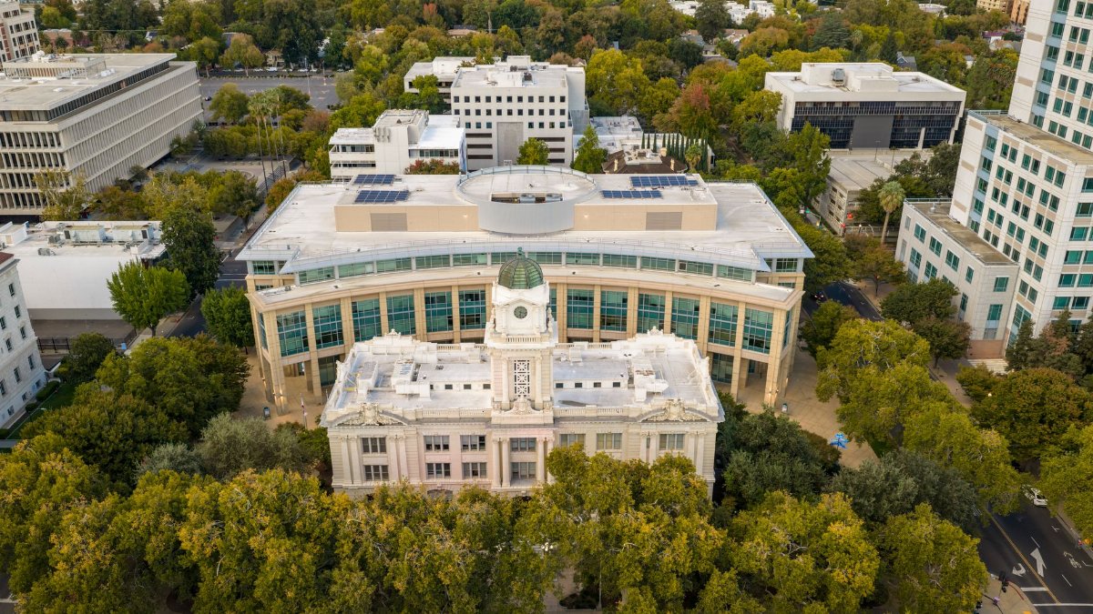 Stunning aerial view of a landmark building surrounded by lush trees in Sacramento, California.