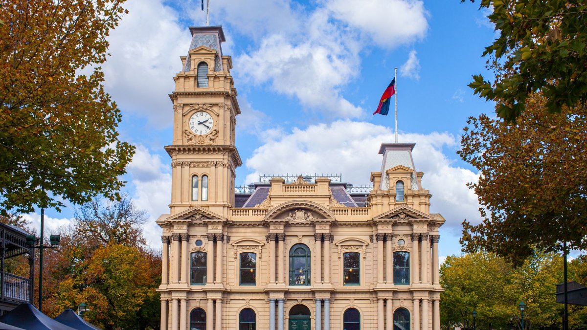 Historic Bendigo Town Hall with bright autumn foliage in Victoria, Australia.