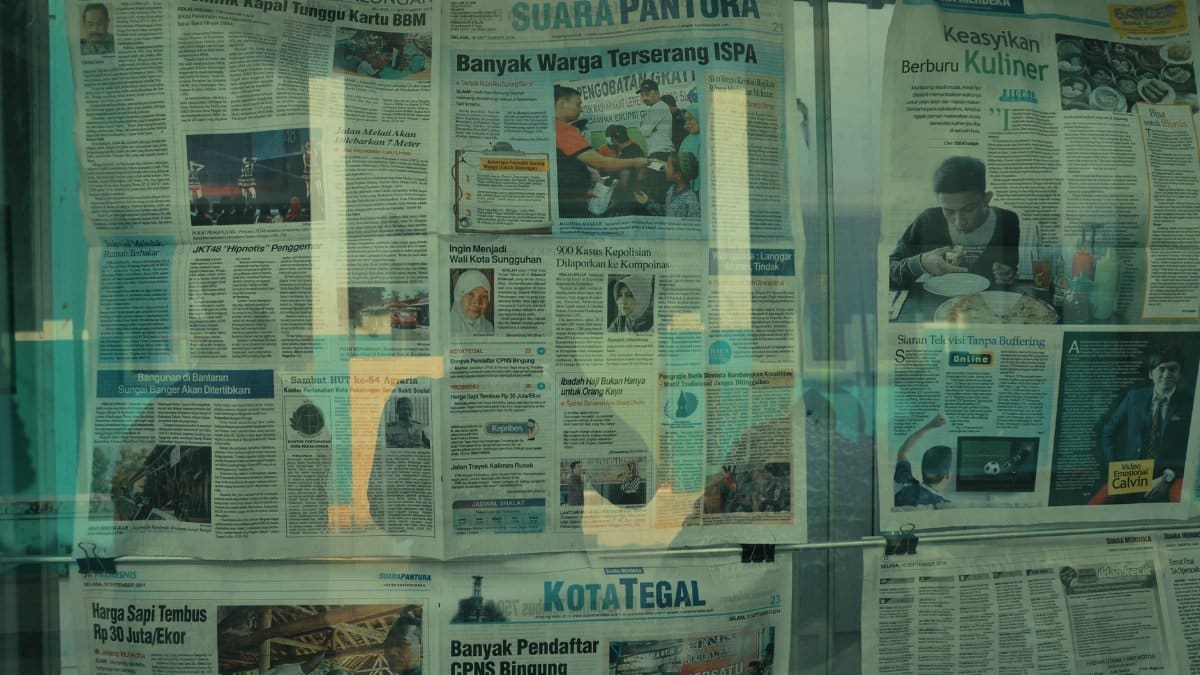 Detailed view of various newspapers on display in Jakarta, Indonesia.