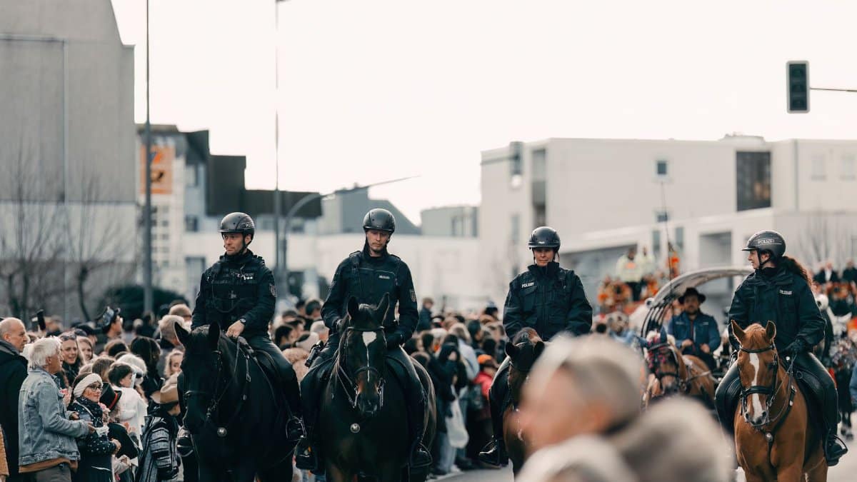 Mounted police officers patrol a street crowd during a public event in Leonberg, Germany.