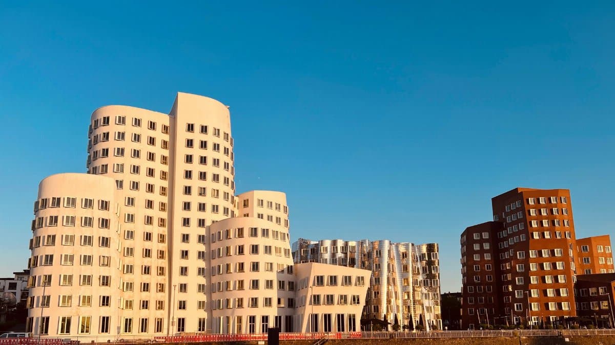 Iconic Gehry Buildings in Düsseldorf's Media Harbour at golden hour.