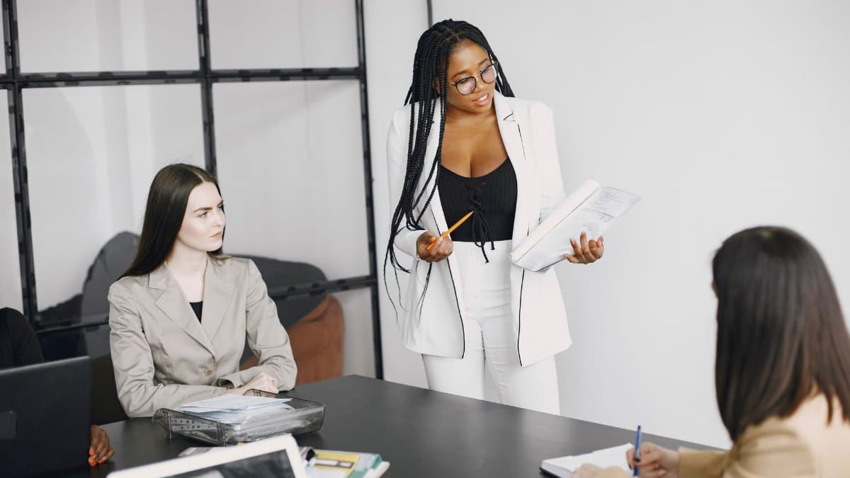 A diverse team of women engaged in a collaborative business meeting in a modern office setting.