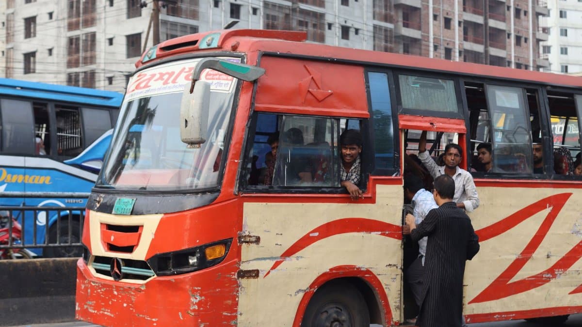 A bustling urban scene with a packed public bus on a busy city street.