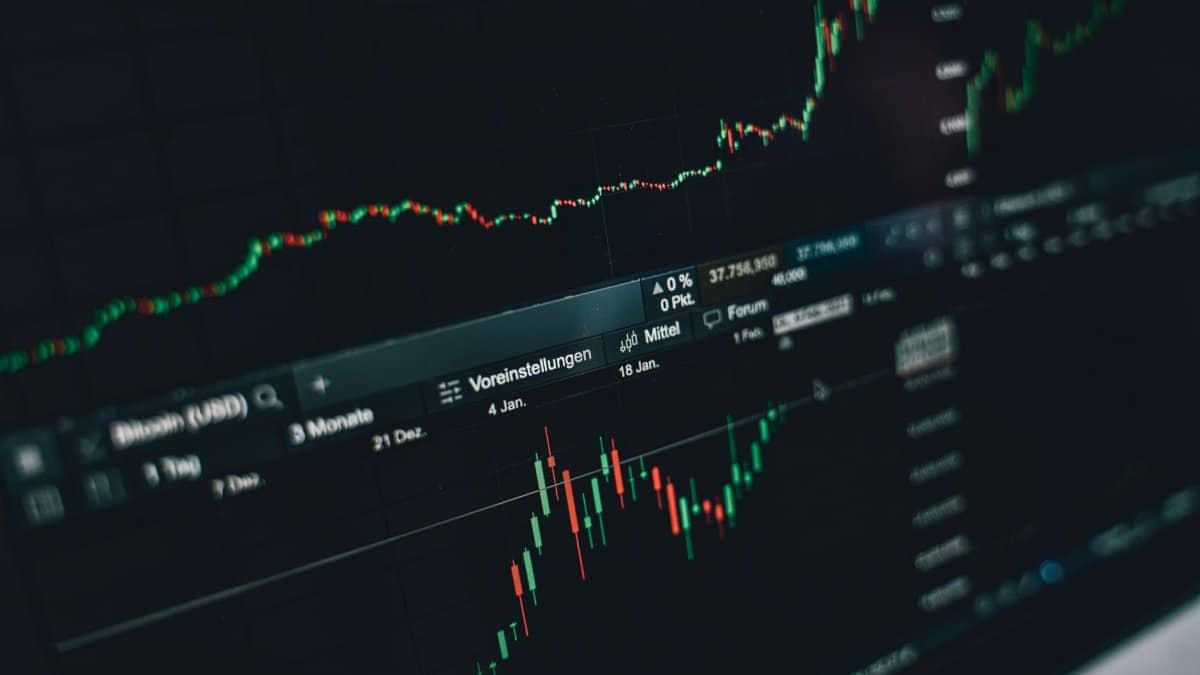 Close-up of a digital market analysis display showing Bitcoin and cryptocurrency price trends.