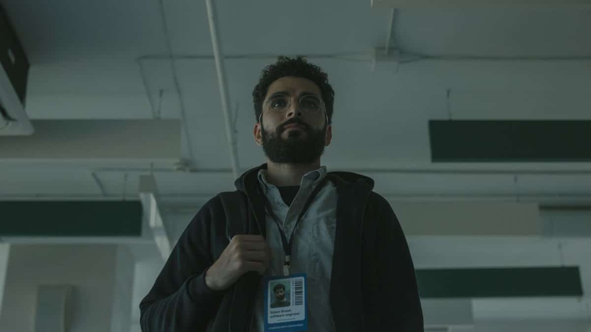 Portrait of a bearded man with ID indoors, signifying technology role.