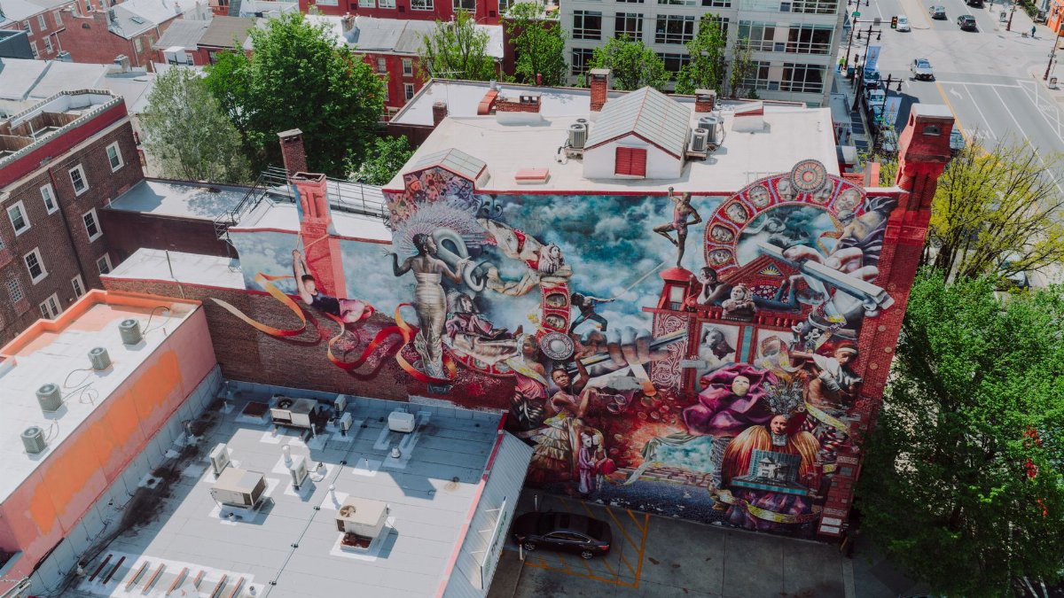 Aerial view of a colorful mural covering the side of a building in Philadelphia, showcasing artistic urban street art.