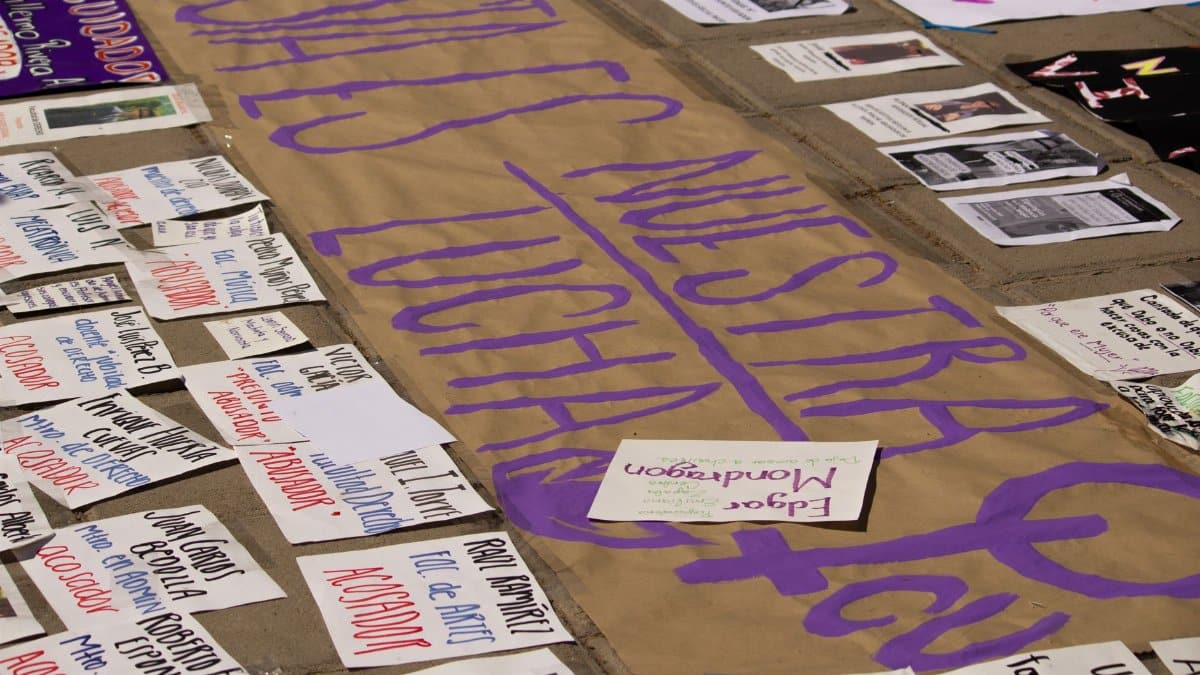 Protest signs laid on the pavement, highlighting messages of unity and social justice.