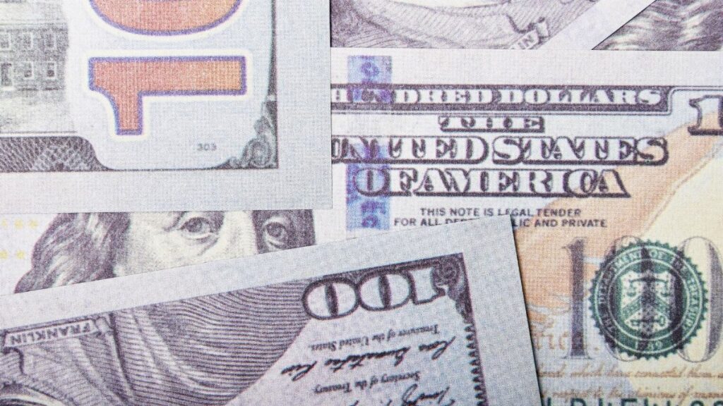 Detailed close-up of US dollar banknotes showcasing currency design and textures.